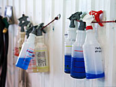 bottles of cleaning solution hanging on wall