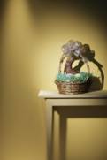 long shot of a basket on a hall table with large areas of plain wall visible as background