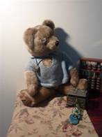 mid-range shot of teddy bear and jewellery box, taken from above, with bear looking out to one side