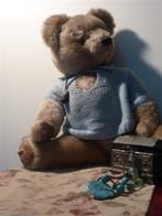 full-frame shot of teddy bear and jewellery box, taken from slightly below, with bear turned half-on towards camera