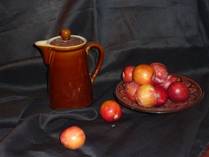 landscape format of the still life arrangement featuring plums and a jug